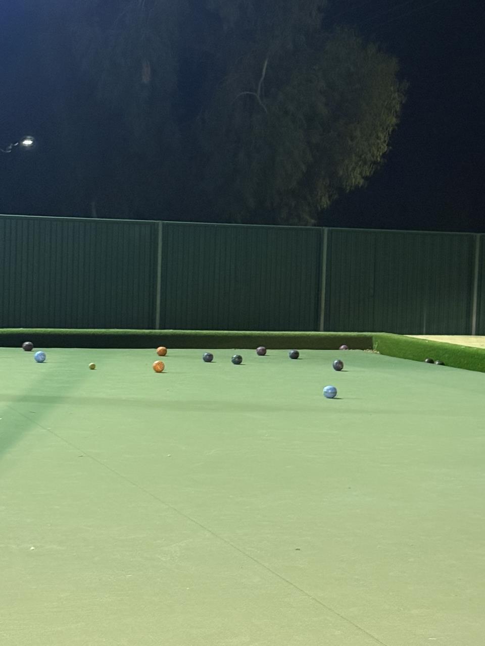 Lawn bowls rink beside the Cue Town Hall at night