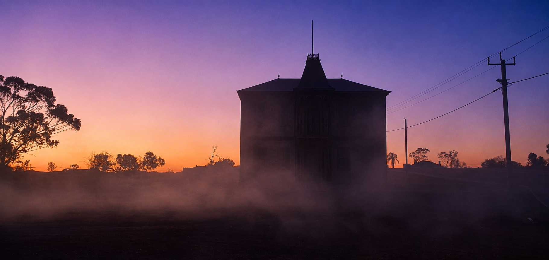 Cue Masonic Lodge silhouetted at dusk