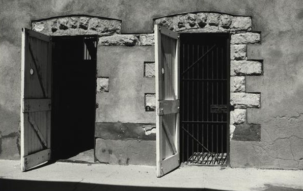 Historic cell doors and barred entrance inside the Old Gaol at Cue