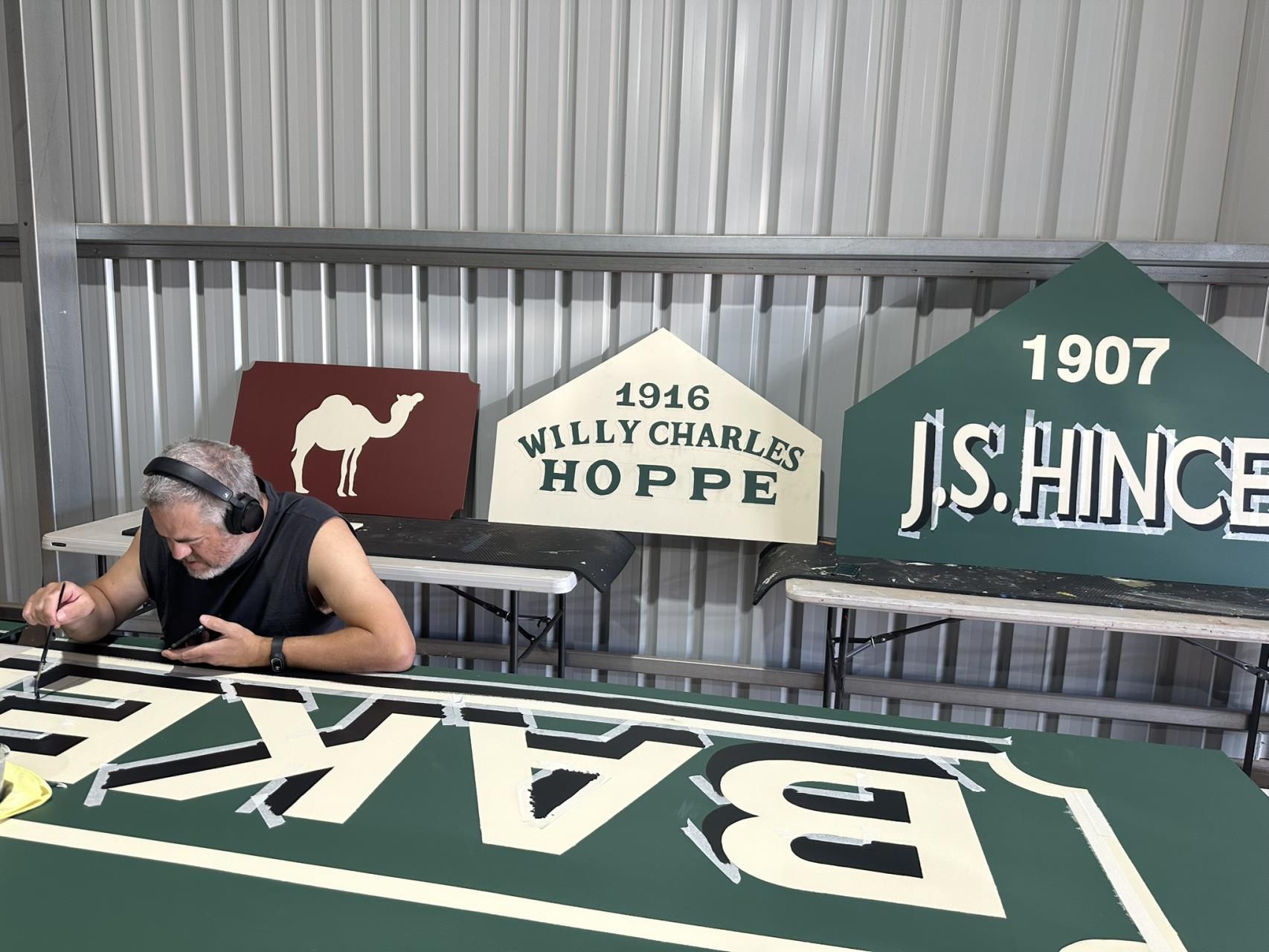 A collection of Stories Above the Street signs being hand painted in the Kaboom Toons workshop