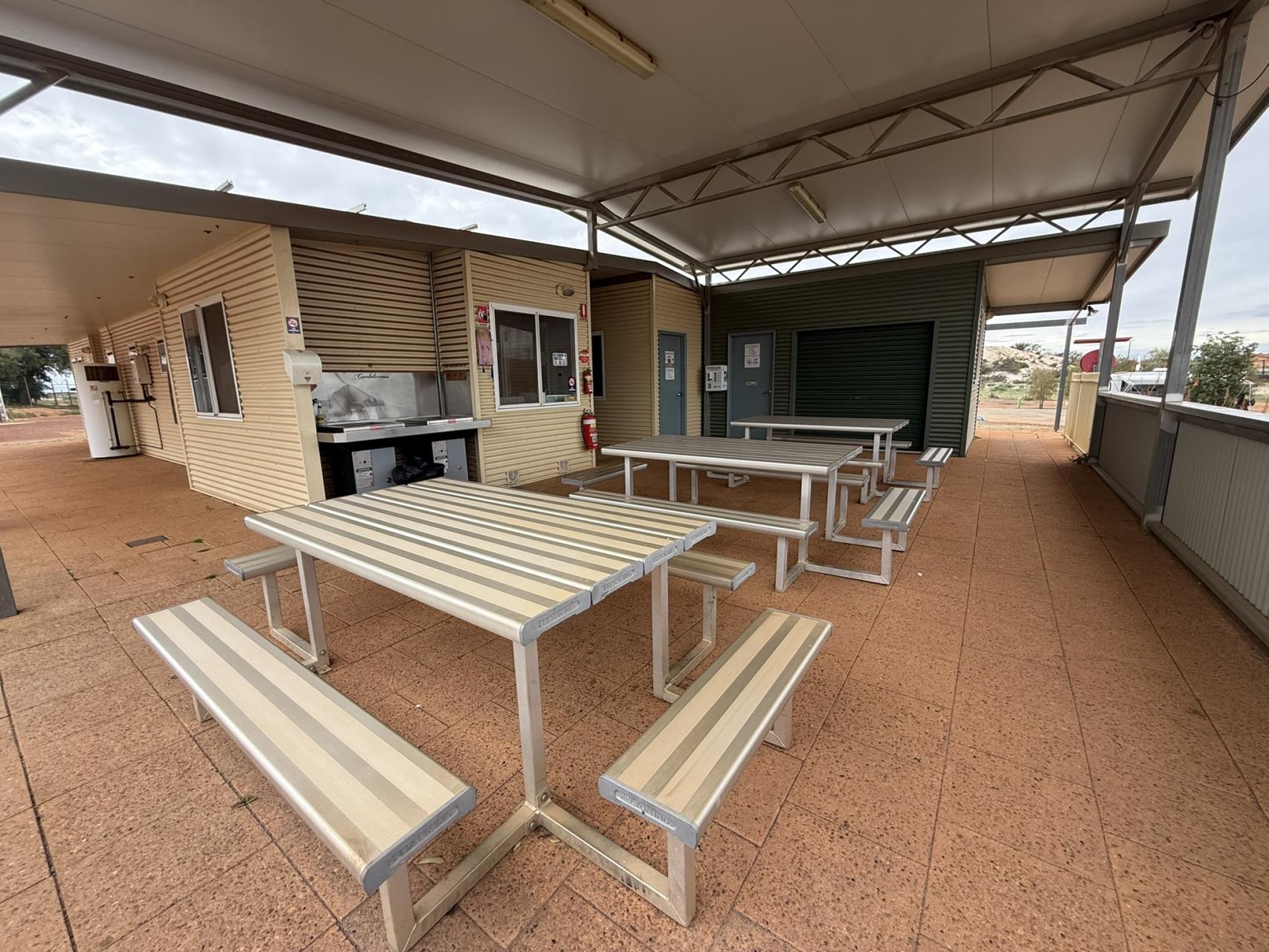 Camp kitchen and communal dining area at Cue Tourist Park